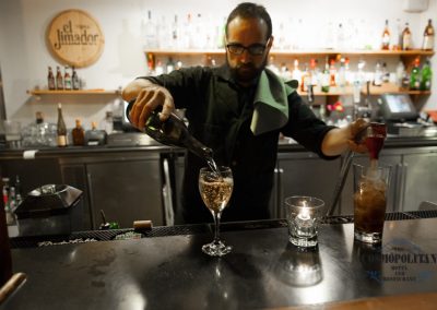 Bartender Pouring in one glass and soda in another