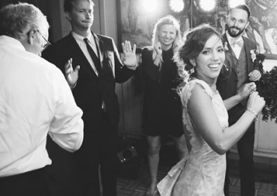 a bride and guests dancing in the parlor